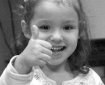 Smiling child gives thumbs up