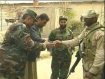 An American shakes the hands of Afghan military officers.