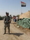 A U.S. Amy 101st Airborne Staff Sergeant named Ryan Ahern stands near an outpost displaying the Iraqi flag. Salem-News.com photo by Tim King