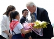 former U.S. President Bill Clinton (R) receiving a bouquet of flowers from a North Korean girl upon his arrival at Pyongyang