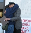 Peace activists Michele Darr and Peter Bergel embrace after an their first meeting with public officials 