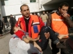 Rescue worker carries a child injured in a recent Israeli bombing attack on Gaza City