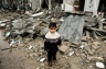 A Palestinian boy amidst the debris of a destroyed house in Gaza Cit