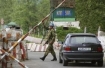 Russian soldier mans a gate in Georgia