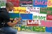 Mississippi State University freshman Darius Crayton writes on a concrete cinder block wall for the 