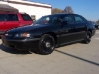 Black Chevy Impala four-door unmarked police car