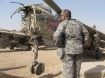 An Oregon National Guard officer inspects a battered Iraqi MiG-23 jet fighter at the Balad Air Base