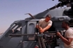 U.S. Air Force Senior Airmen Derand Javier and Chris Moore, both weapons specialists with 64th Aircraft Maintenance Unit, test the head spacing of a .50-caliber machine gun on an HH-60G Pave Hawk helicopter on Balad Air Base, Iraq