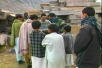 Here an American soldier hands out humanitarian aid to local villagers in Afghanistan`s Pesh Valley.
