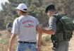 Dr. Qumsiyeh being led away by an Israeli soldier