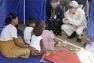 Secretary-General Ban Ki-moon (right) comforting children at a tent camp housing survivors of Cyclone Nargis