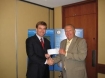 NADDI President John Burke presents Attorney General Conway with a Seed Grant for $50,000