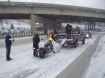 Oregon State troopers help a motorcyclist load his Harley onto a truck