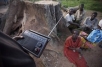 A group of people listen to the radio in Soroti District, Uganda. © 2008 Dan Chung