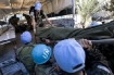 UN soldiers help evacuate the injured. 