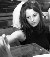 women placing ballot in ballot box