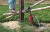 Treadle pumps are foot-powered pumps that sit on top of a well and irrigate small plots of land. (Photo: IDE)