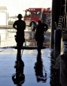 Two Hillsboro firefighters push water from an unheated warehouse flooded by a broken sprinkler pipe.