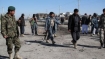 Afghan policemen inspect the site of a bomber attack in the city of Lashkar Gah, Helmand province on February 29, 2012.