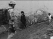 U.S. soldier passing children in Afghanistan