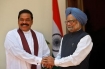 Sri Lankan President Mahinda Rajapaksa, left, shakes hands with Indian Prime Minister Manmohan Singh