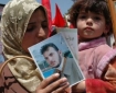 Families of political prisoners rally in Hebron on the International Day of Solidarity with Palestinian Prisoners