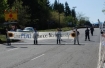 Trident protestors with banner on roadway