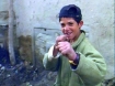 Boy in Kabul, Afghanistan makes fists toward camera