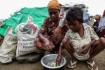 A Rohingya family have a meager meal in a camp for displaced Muslim families near Sittwe