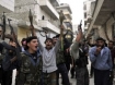 Syrian rebel fighters hold up their guns as they shout slogans in a street in the northern city of Aleppo (AFP Photo / Tauseef Mustafa)