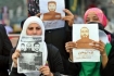 Demonstrators in the West Bank city of Nablus hold posters in solidarity with hunger striking prisoners