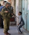 Israeli soldier menacing a child