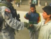 Afghan child shakes US soldier's hand while 2nd kid gives thumbs up