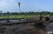 Muslim Rohingya man standing next to the ruins of his burned house on the edge of the Aung Mingalar quarter