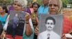 Sri Lankan Tamil women hold up photographs of their missing sons