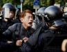 Police lead away a protester during clashes.