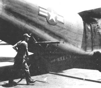 U.S. airman preparing a plane loaded with Agent Orange prior to a mission over Vietnam.