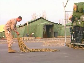 A US airman offloads gear at the Ganci air base; located at Bishkek's Manas airport