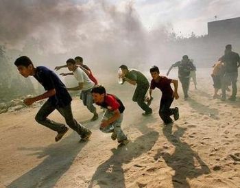 Residents in Gaza run for cover from an Israeli attack