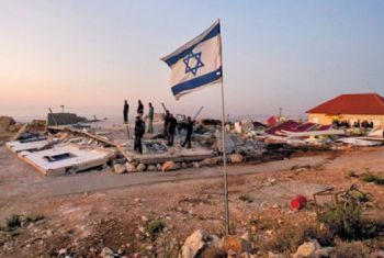 Israeli settlers destroy a Palestinian home