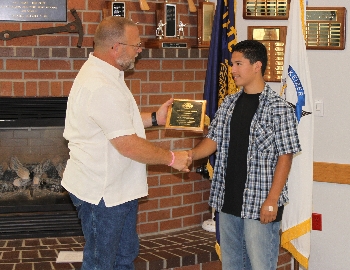 KFD Board President Greg Ego presesnts Wickman Award to B.J. Delagado