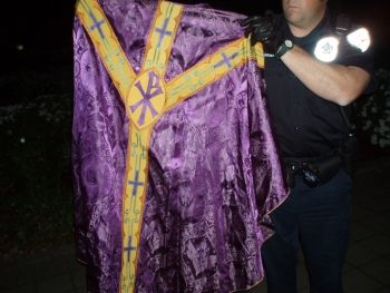 Salem Police officer shows one of the church robes recovered Monday night, Salem, Oregon, 6  6 07