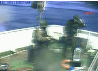 Video frame shows Israeli commandos on the deck of the the same vessel they shot several people aboard.