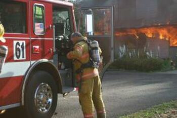 Firefighter and burning house