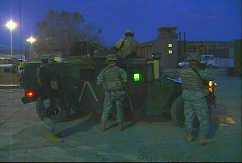 American soldiers preparing for a mission in Afghanistan before dawn