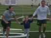 A couple of student athletes play with children at the recent Quack in Action day